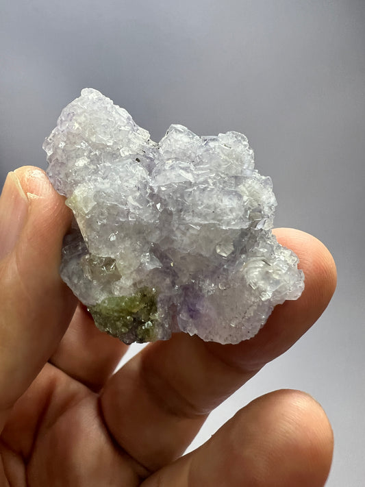 a person holding a piece of white rock